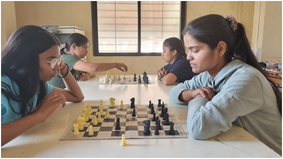 Students playing cricket on the college ground with full team participation